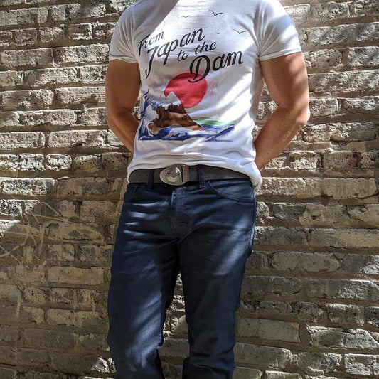 Bryan leaning in an alley with dappled light wearing a new limited edition leather product - the Dial on Slate Grey full grain leather belt