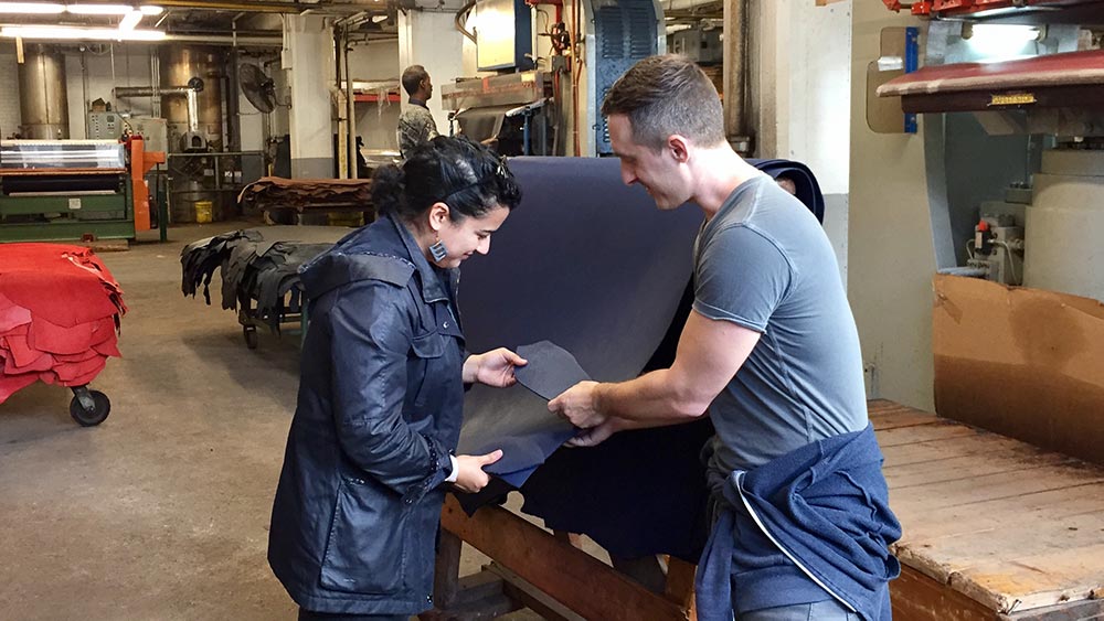 Obscure Belts Bryan and Cristina inspecting a full grain leather cow hide at Seidel Tannery in Milwaukee, Wisconsin