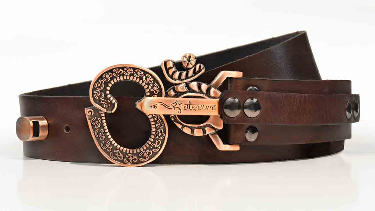 copper belt buckle with ohm texture on brown leather belt 