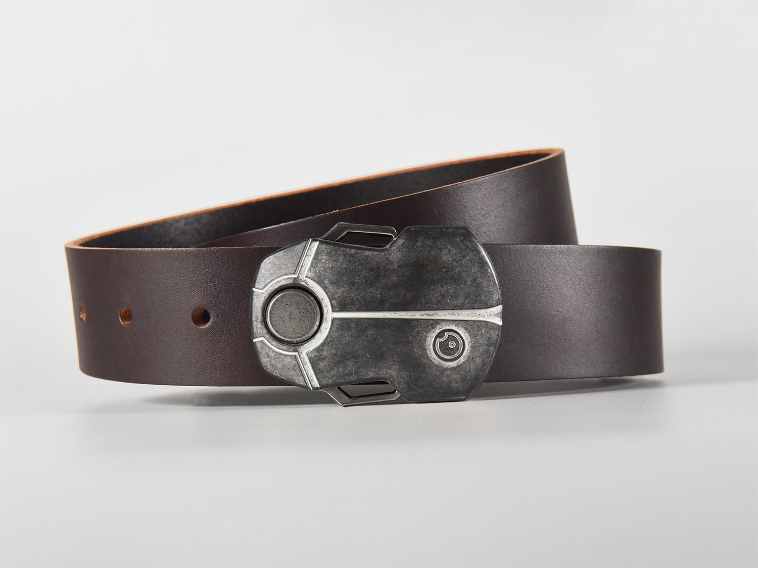 Dark brown leather belt with a metallic buckle shaped like a Scarab Beetle on a white background