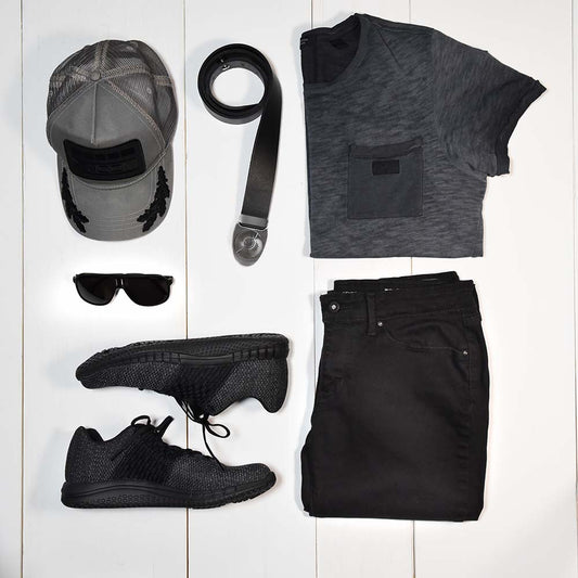 men's fashion inspiration style flat lay with accessories. all-black casual wear outfit with hat, sunglasses, sneakers and a cool leather belt