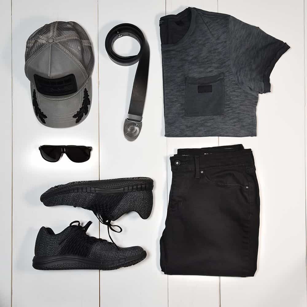 men's style flat lay. outfit inspiration for an all-black casual wear outfit with had, sunglasses, sneakers and a cool leather belt