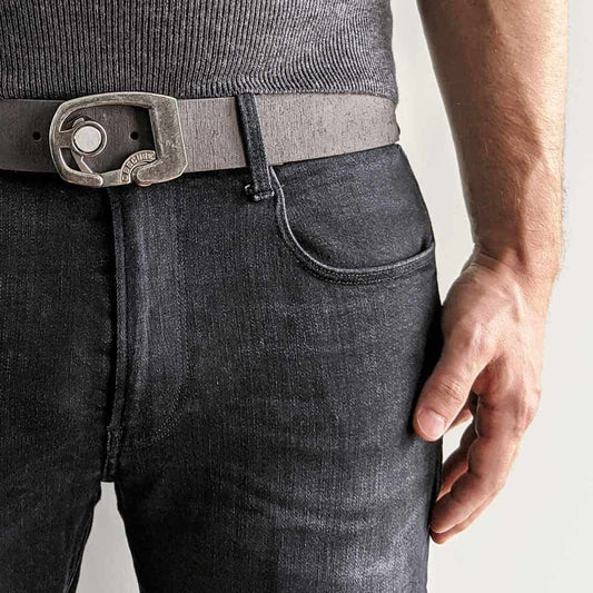 person wearing dark jeans and a sweater with a dark grey belt. grey belts are a trending style