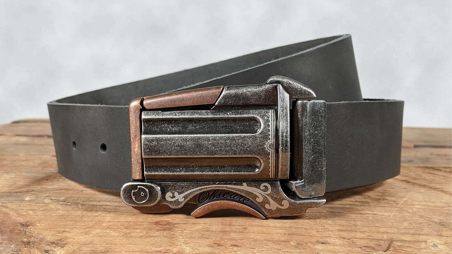 western revolver gun belt buckle with click button lock on handmade leather belt. heavy duty hardware, thick weight leather.