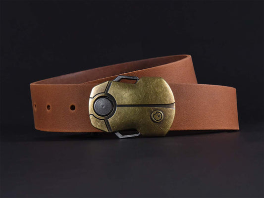 Light brown leather belt with a brass buckle shaped like a Scarab Beetle on a dark background