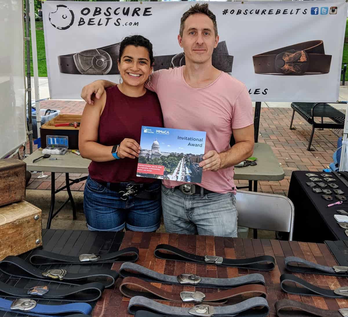 Bryan and Cristina accepting an award for their unique belts.