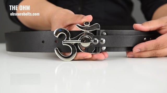 Slide the metal pin out of the ohm belt buckle to open it. unscrew the sizing piece to adjust the size of the leather belt