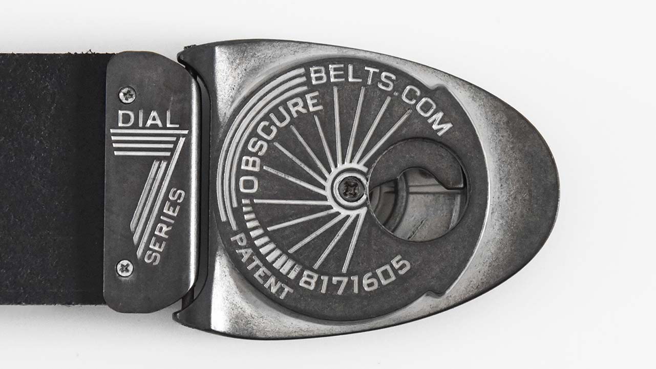Back of the Stone Dial belt buckle has a retro starburst design in off-white that accents the color of the antiqued metal. US Patent 8171605